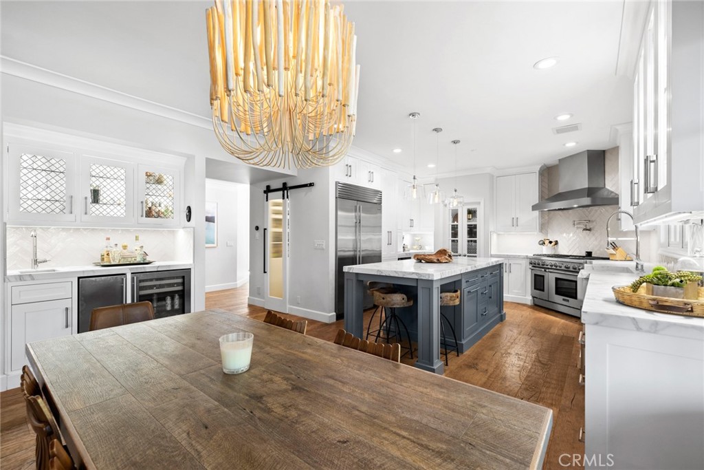 4 Percheron Coto de Caza, CA 92679 - Photo 7 of 44 a kitchen with stainless steel appliances granite countertop a refrigerator a stove top oven a sink dishwasher and white cabinets with wooden floor