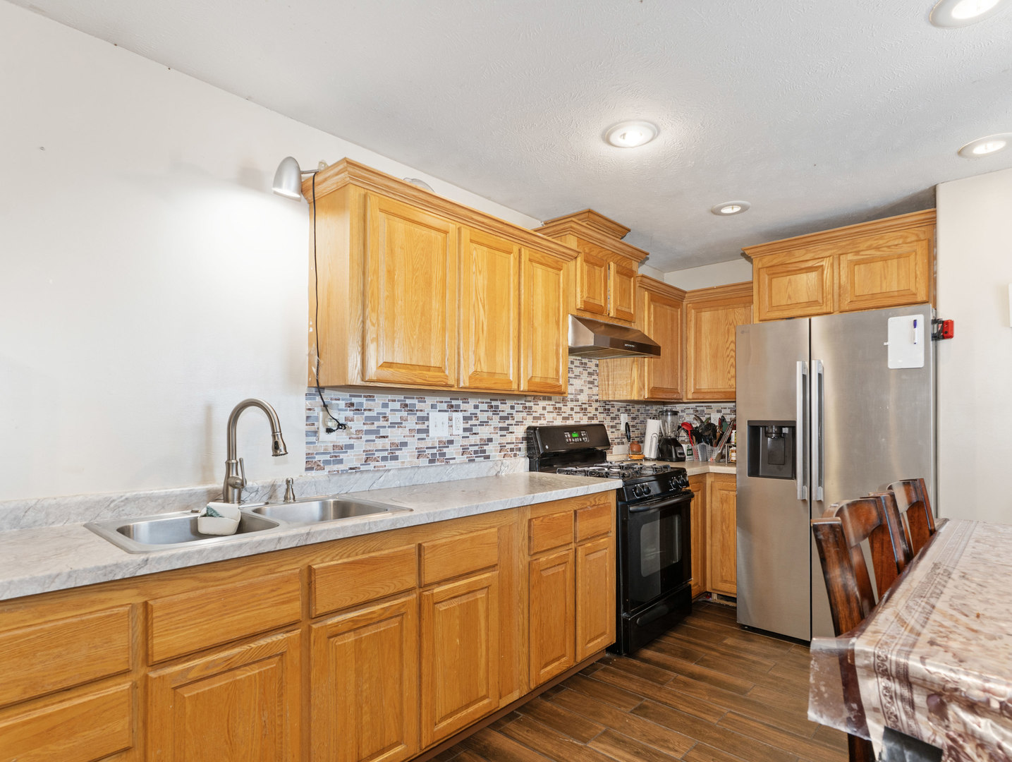31 Peggy Drive Sandwich, IL 60548 - Photo 12 of 17 a kitchen with sink a refrigerator and wooden cabinets