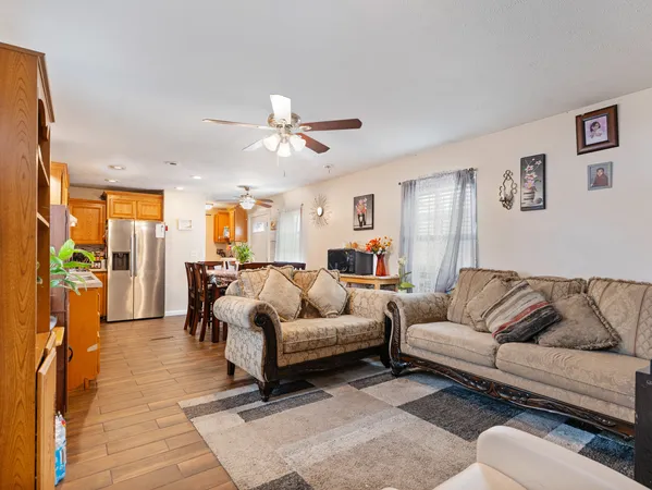 a living room with furniture ceiling fan and a rug