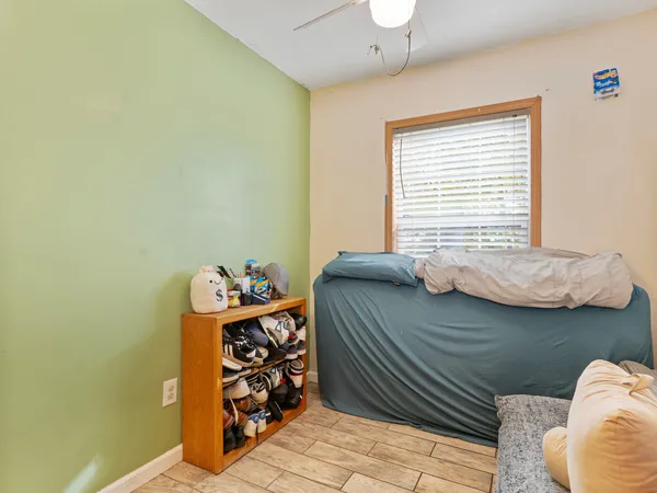 a bedroom with a bed and a window