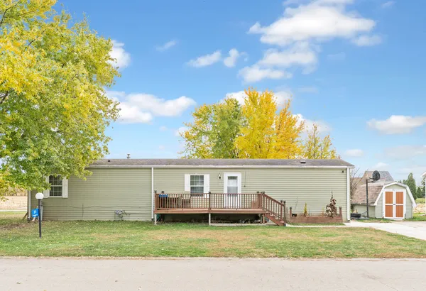 a view of a house with a patio and a yard