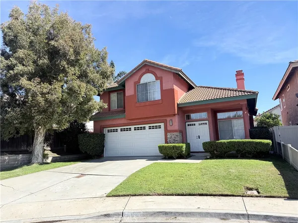 a front view of a house with a yard and a garage