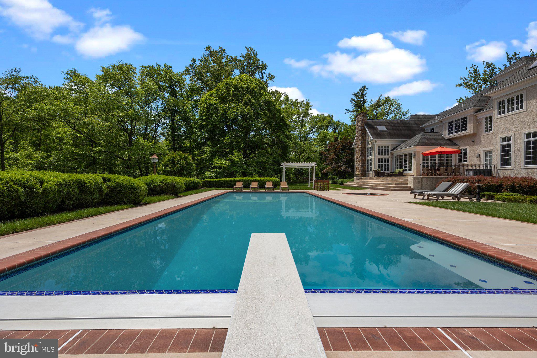 1049 McKean Road Ambler, PA 19002 - Photo 13 of 93 a view of a swimming pool with a garden and trees