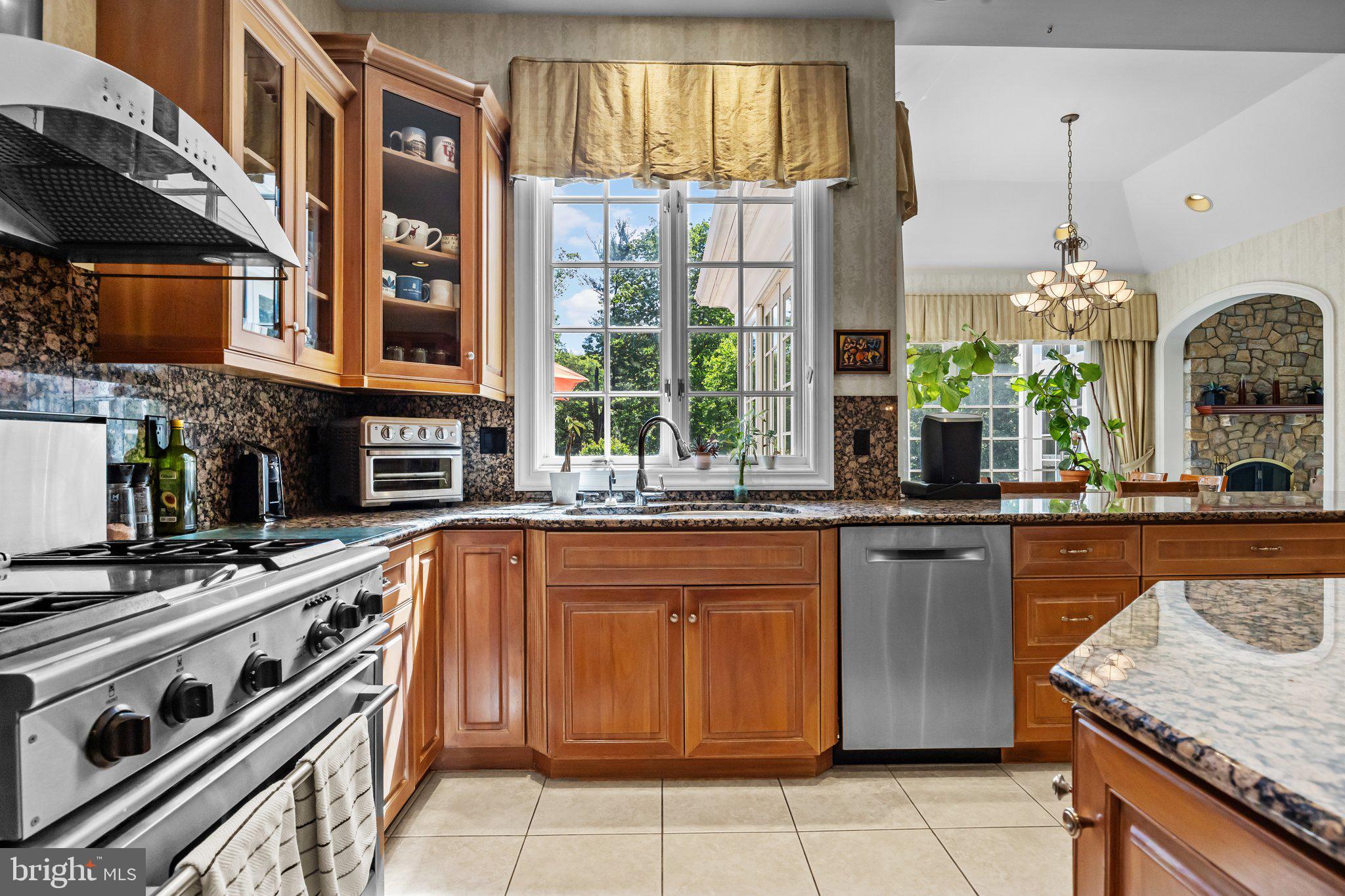 1049 McKean Road Ambler, PA 19002 - Photo 21 of 93 a kitchen with stainless steel appliances granite countertop a stove a sink and a microwave