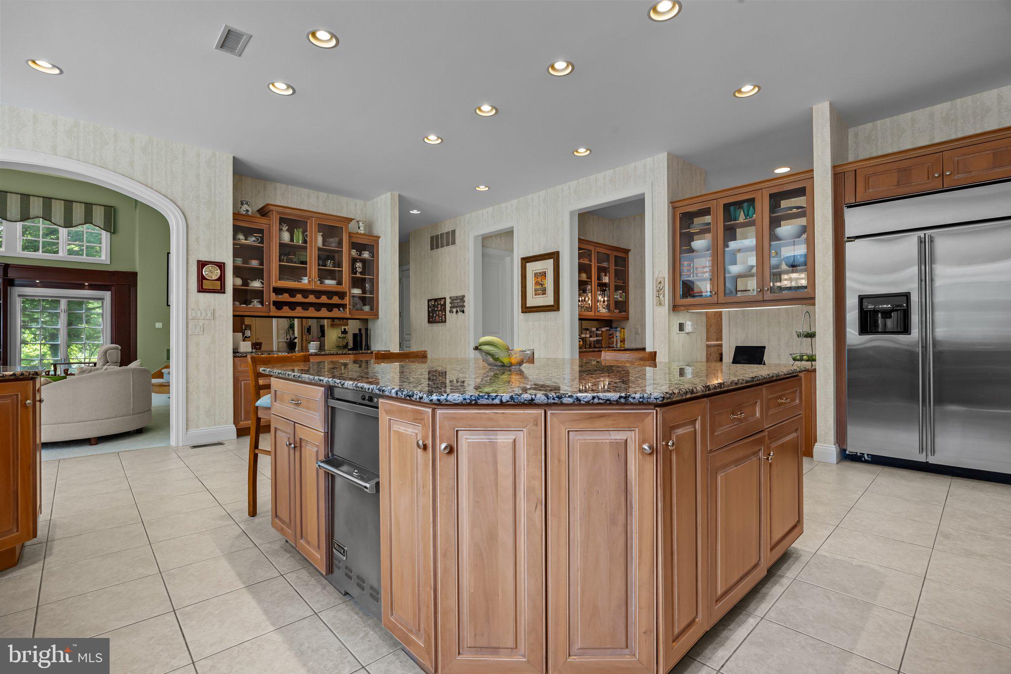 1049 McKean Road Ambler, PA 19002 - Photo 23 of 93 a kitchen with stainless steel appliances kitchen island granite countertop a refrigerator and a stove top oven