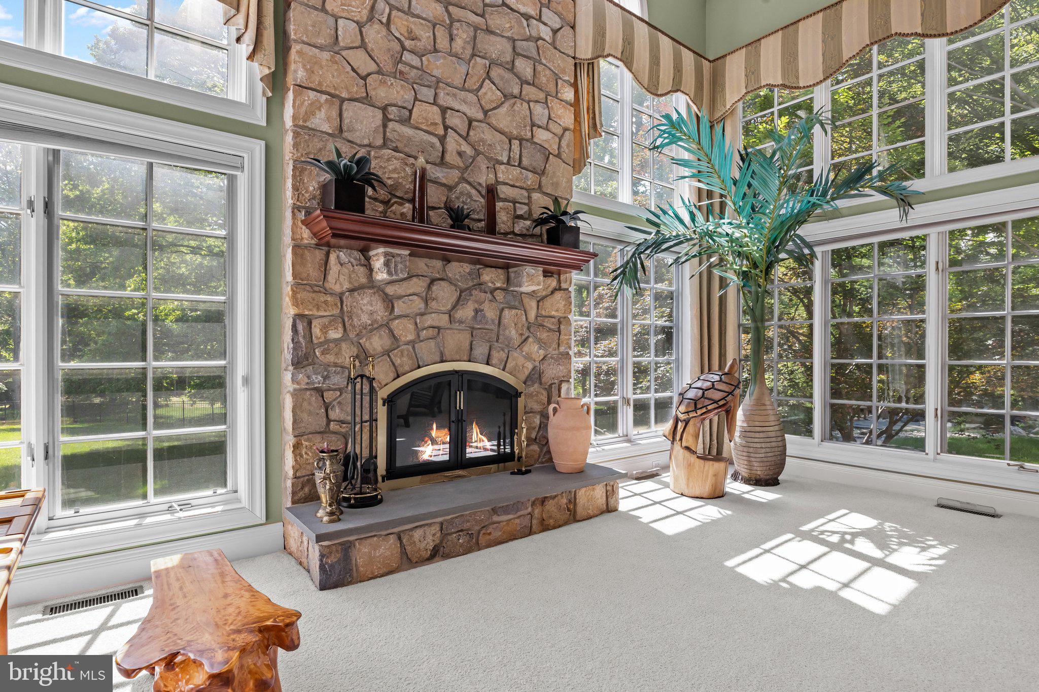 1049 McKean Road Ambler, PA 19002 - Photo 32 of 93 a living room with a fireplace and a large window