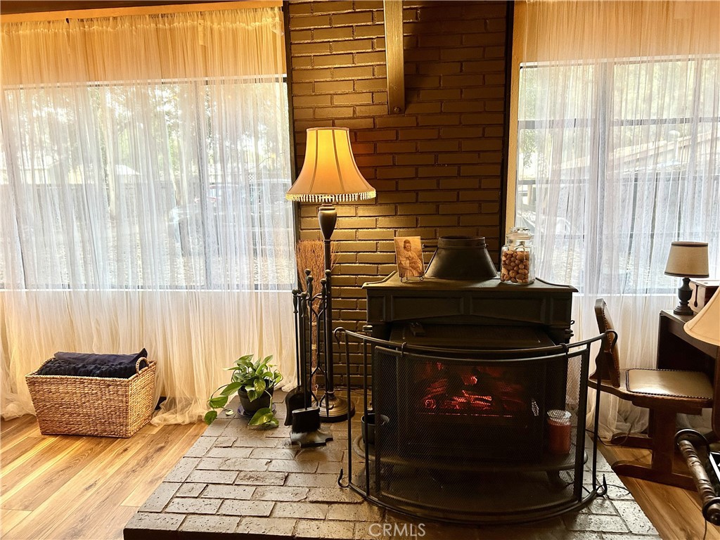 28639 Rostrata Avenue Lake Elsinore, CA 92532 - Photo 11 of 43 a living room with a fireplace and a table