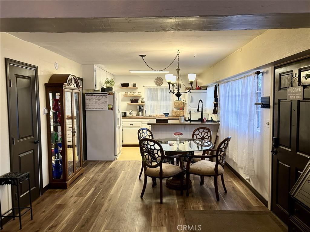 28639 Rostrata Avenue Lake Elsinore, CA 92532 - Photo 12 of 43 a view of a dining room with furniture and wooden floor