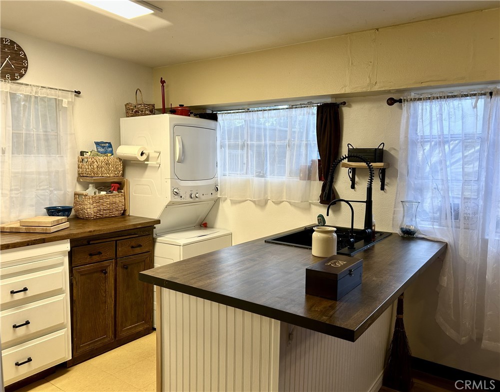 28639 Rostrata Avenue Lake Elsinore, CA 92532 - Photo 14 of 43 a kitchen with sink a refrigerator and cabinets
