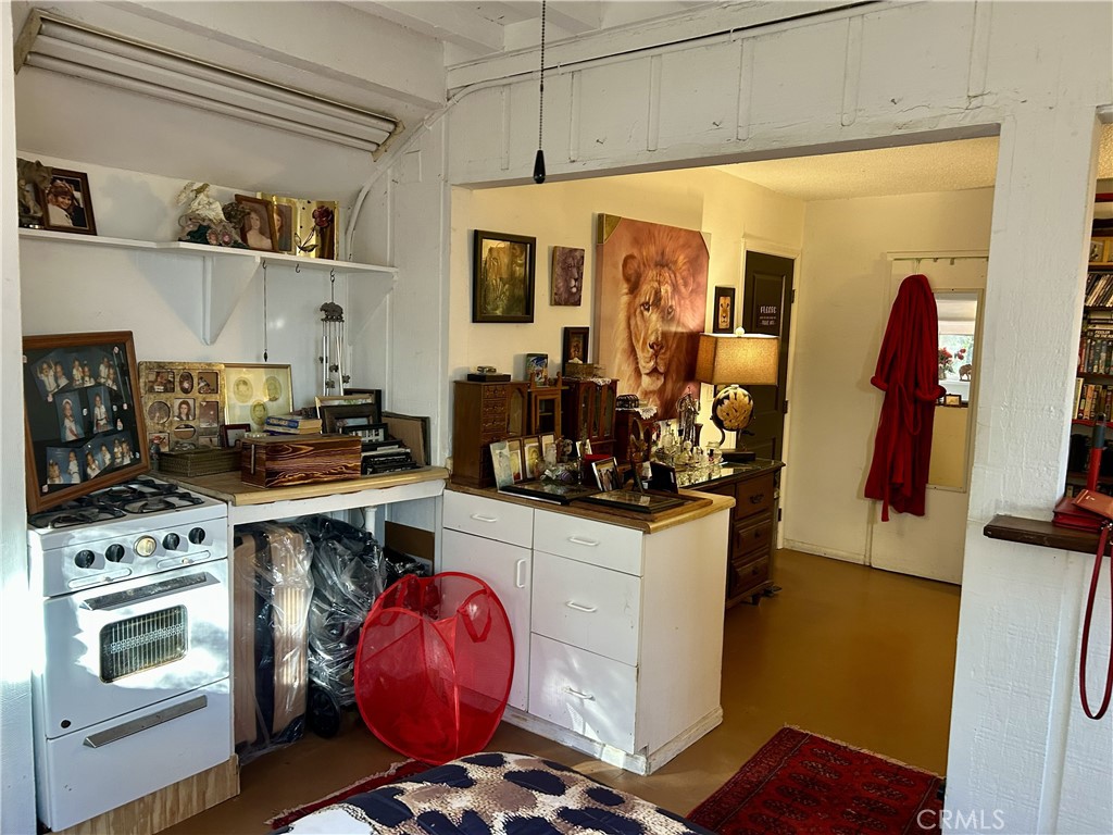 28639 Rostrata Avenue Lake Elsinore, CA 92532 - Photo 18 of 43 a kitchen with stainless steel appliances a stove a sink and a refrigerator