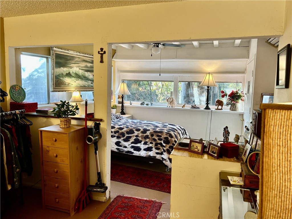 28639 Rostrata Avenue Lake Elsinore, CA 92532 - Photo 19 of 43 a bedroom with furniture and a large window