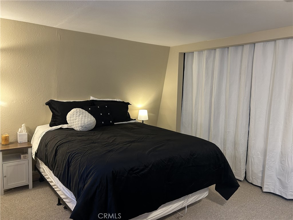 28639 Rostrata Avenue Lake Elsinore, CA 92532 - Photo 25 of 43 a bedroom with a bed and window