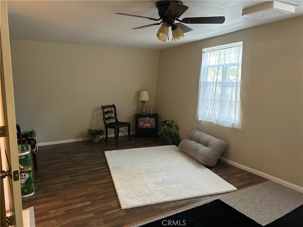 28639 Rostrata Avenue Lake Elsinore, CA 92532 - Photo 27 of 43 a living room with furniture and a wooden floor