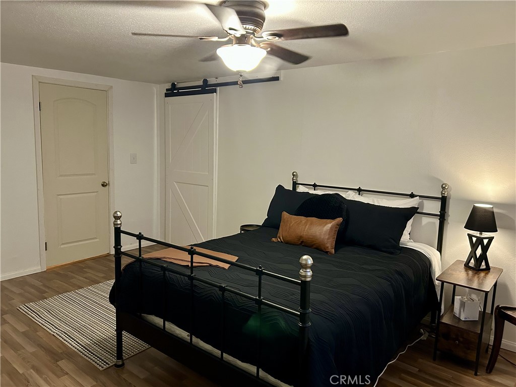 28639 Rostrata Avenue Lake Elsinore, CA 92532 - Photo 33 of 43 a bed sitting in a bedroom next to a lamp