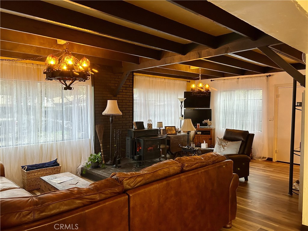 28639 Rostrata Avenue Lake Elsinore, CA 92532 - Photo 5 of 43 a room with furniture and wooden floor