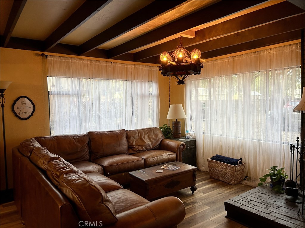 28639 Rostrata Avenue Lake Elsinore, CA 92532 - Photo 6 of 43 a living room with furniture and a large window