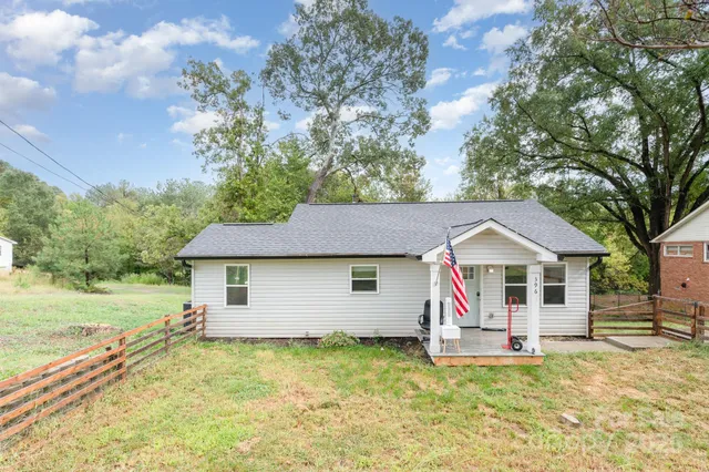 a view of a house with a yard patio and fire pit