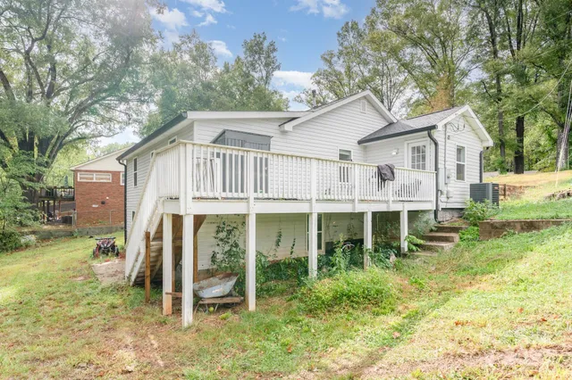 a view of a house with backyard porch and sitting area