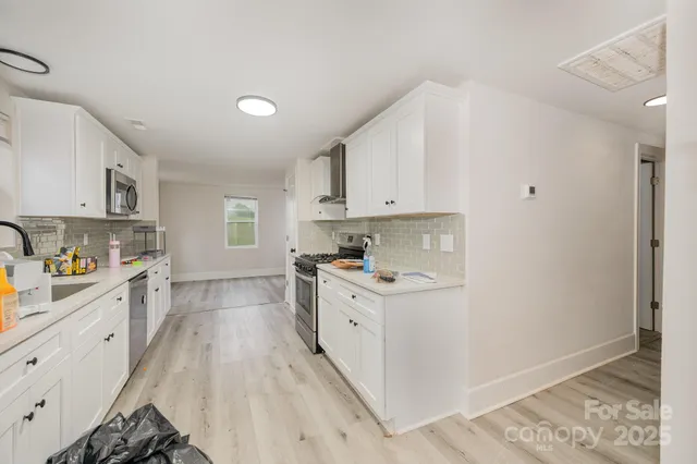 a kitchen with a sink a stove and cabinets