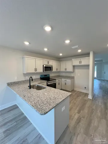 a kitchen with a center island and stainless steel appliances