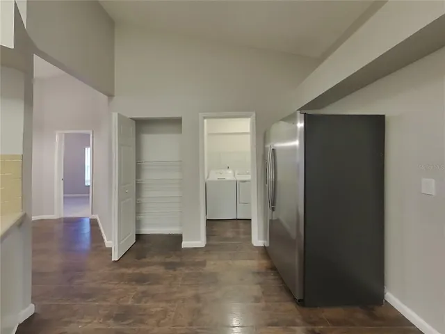 an empty room with closet and wooden door