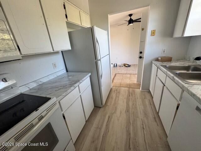 2232 Flower Tree Circle Melbourne, FL 32935 - Photo 2 of 13 a kitchen with a sink a refrigerator freezer a washer and dryer