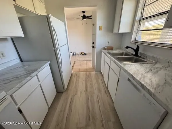 a kitchen with sink a refrigerator a washer and dryer