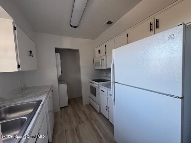 2232 Flower Tree Circle Melbourne, FL 32935 - Photo 5 of 17 a kitchen with stainless steel appliances a refrigerator a sink and white cabinets