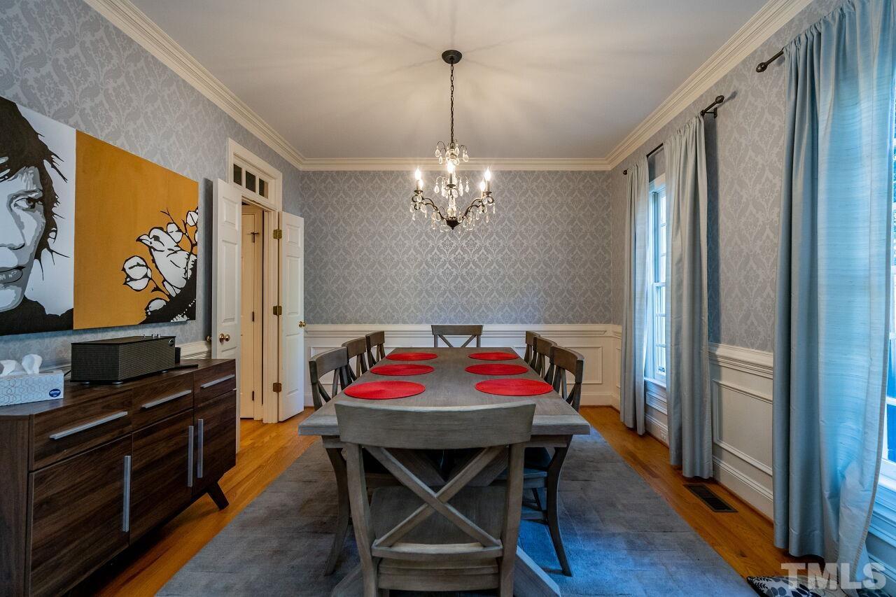 1904 White Oak Road Raleigh, NC 27608 - Photo 7 of 30 a view of a dining room with furniture and wooden floor