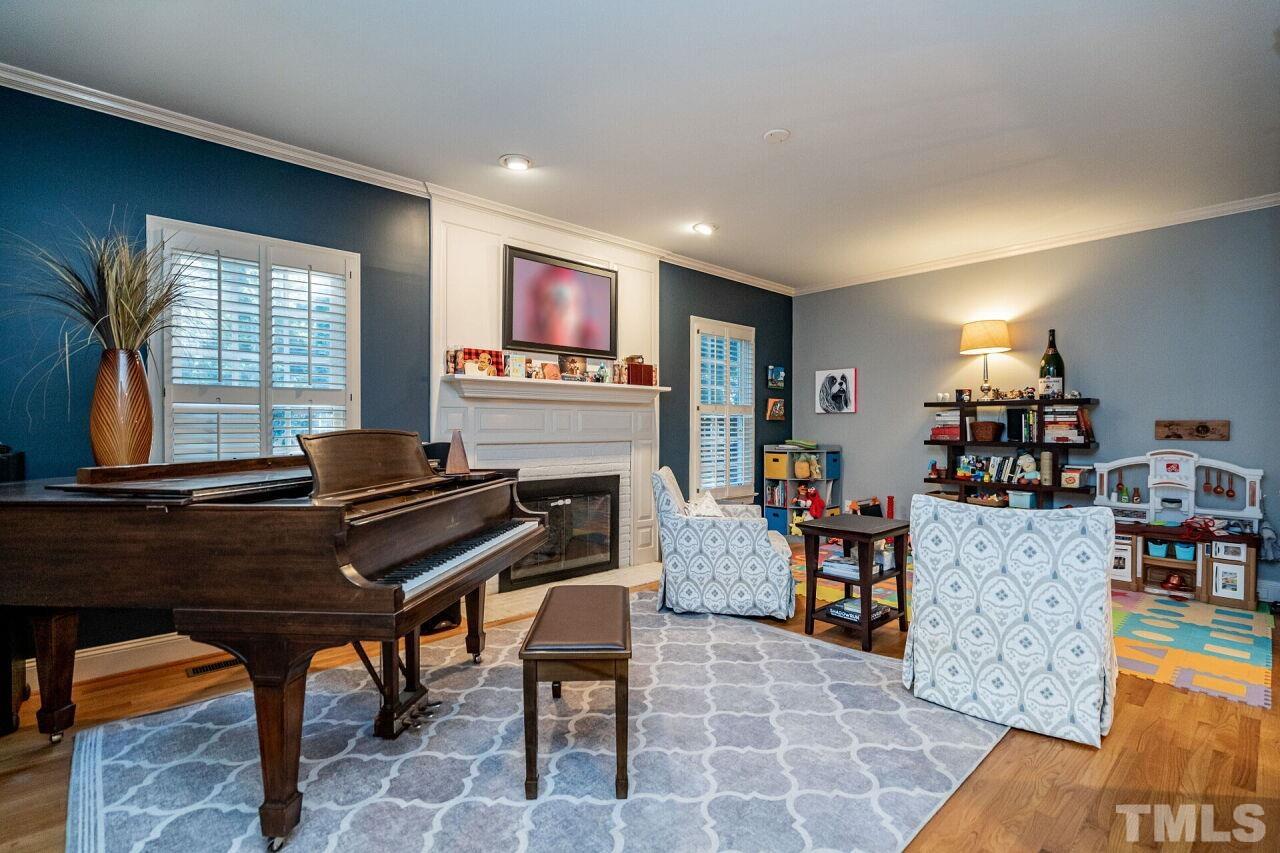 1904 White Oak Road Raleigh, NC 27608 - Photo 9 of 30 a living room with furniture a piano and a bookshelf