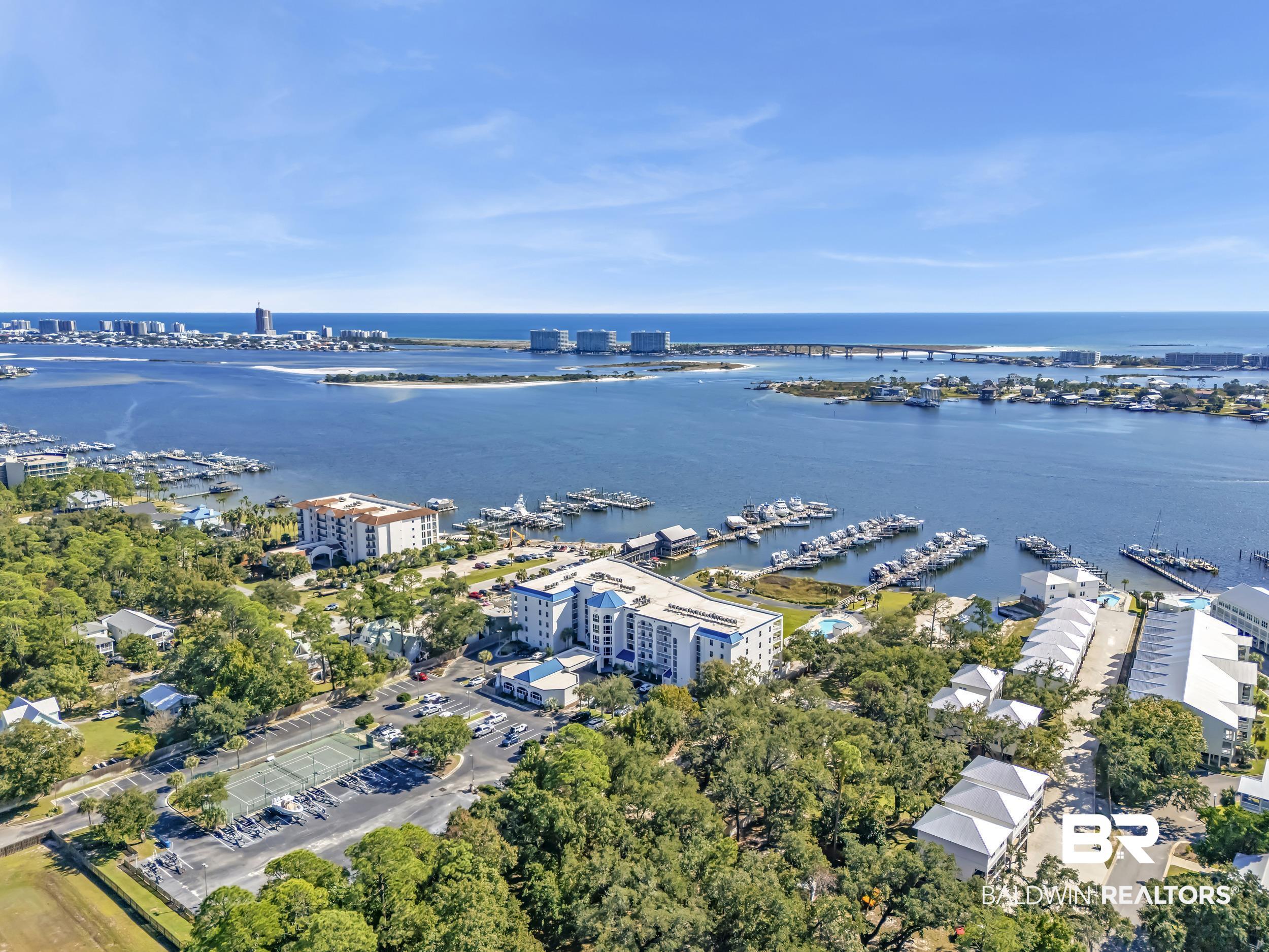 27282 Canal Road, Unit 104 Orange Beach, AL 36561 - Photo 72 of 79 Bird's eye view of a marina and a large body of water