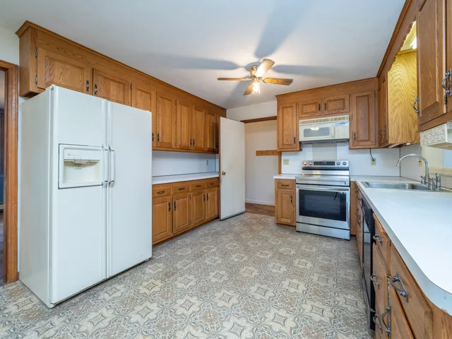 a kitchen with stainless steel appliances a refrigerator sink and cabinets