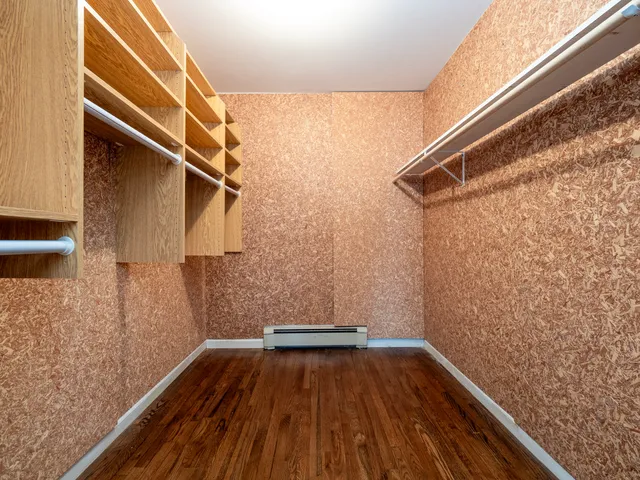 a view of walk in closet with clothes and shoes