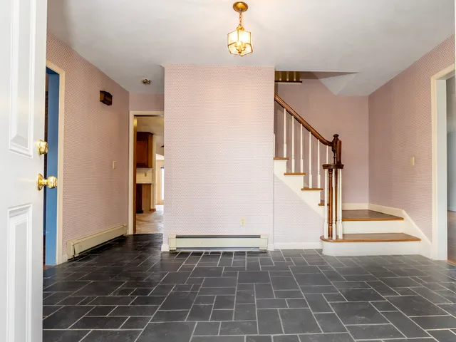 a view of entryway with wooden floor and stairs