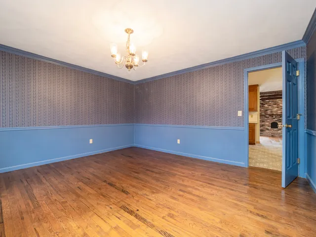 a view of an empty room and wooden floor