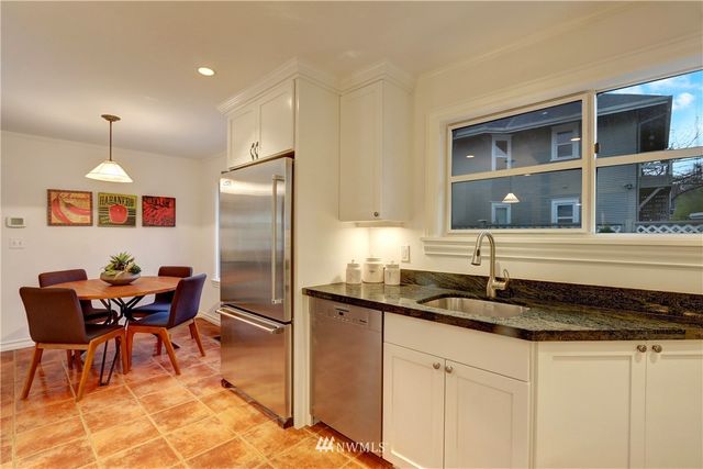 a kitchen with granite countertop sink cabinets and stainless steel appliances