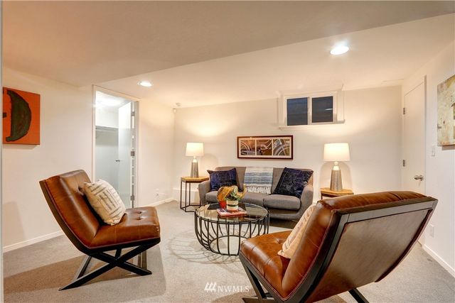 a living room with furniture a rug and a chair