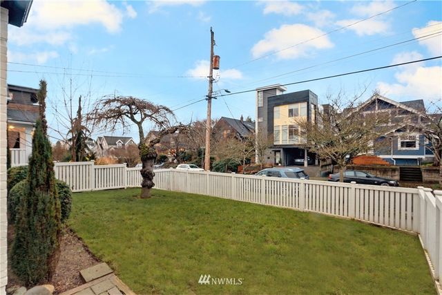 a view of a house with a yard and a fence