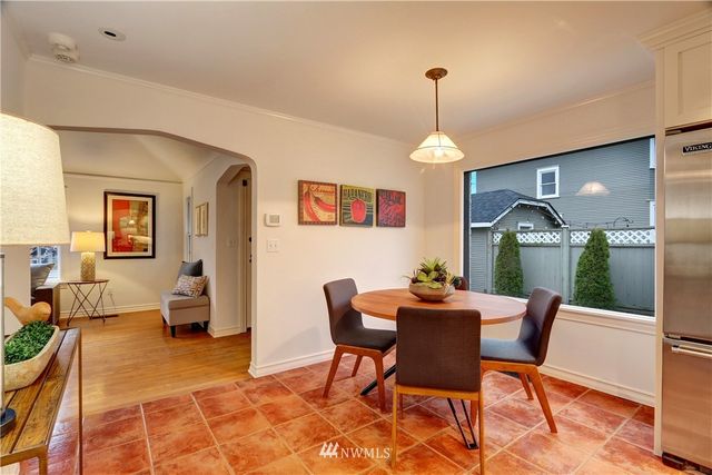 a dining room with furniture a chandelier and wooden floor