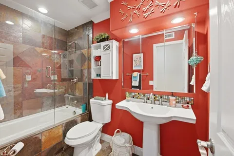 a bathroom with a sink toilet and shower