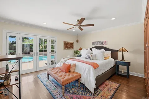 a bedroom with bed and a large window