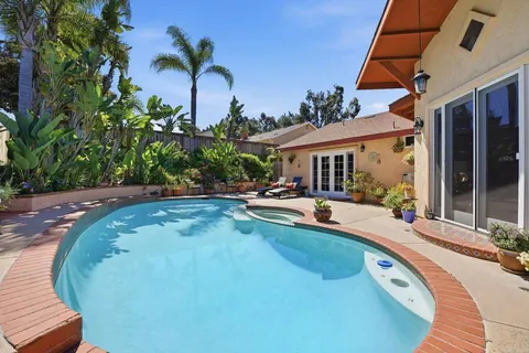 swimming pool view with a garden space