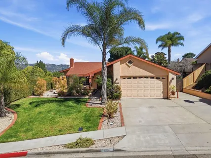 a view of a house with a yard and garage