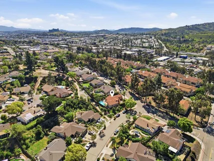 an aerial view of residential houses with city view