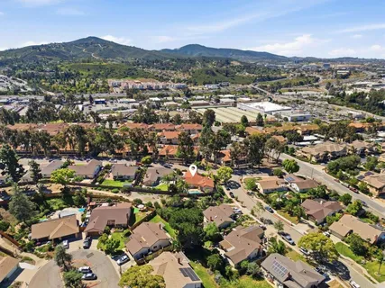 an aerial view of residential houses with city view