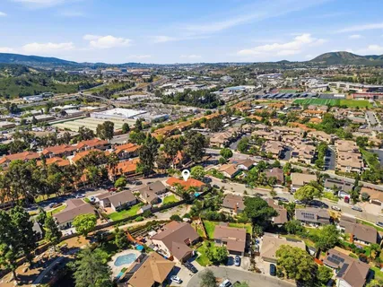 an aerial view of residential houses with city view