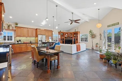 a living room with stainless steel appliances kitchen island granite countertop furniture and a view of kitchen