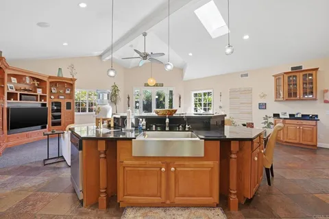 a large kitchen with a table and chairs