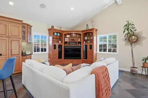 a living room with furniture a front door and a flat screen tv