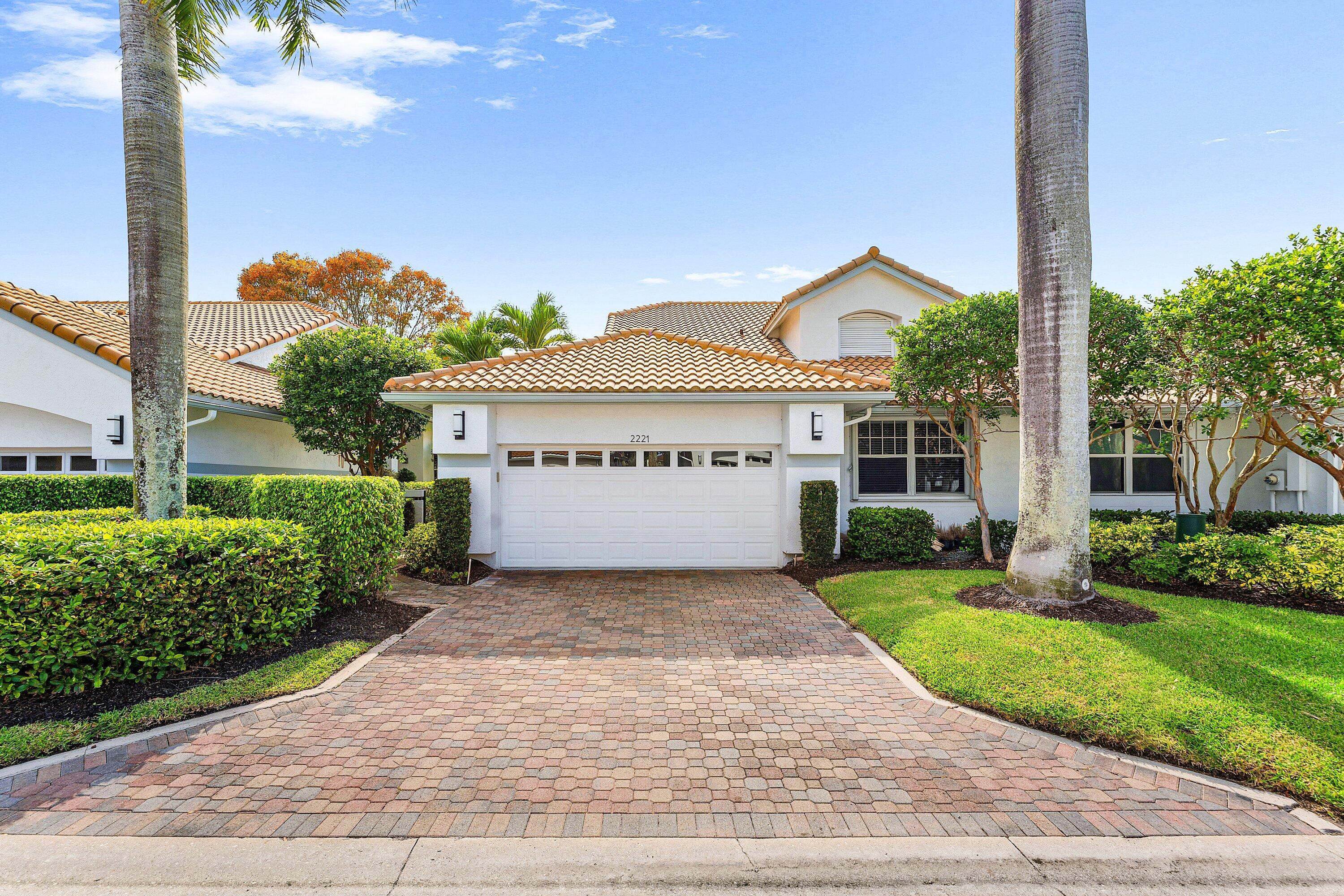 2221 Northwest 62nd Drive Boca Raton, FL 33496 - Photo 1 of 62 a view of a house with a yard and potted plants